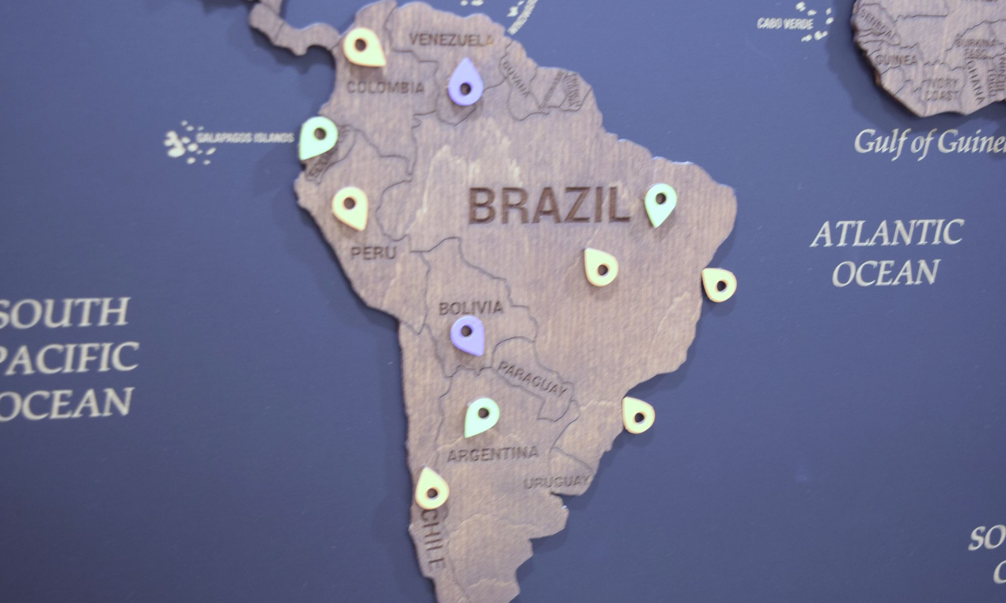 Client pins across South America on the office map