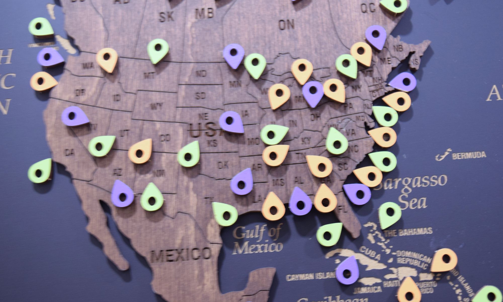 Client pins across the United States on the office map