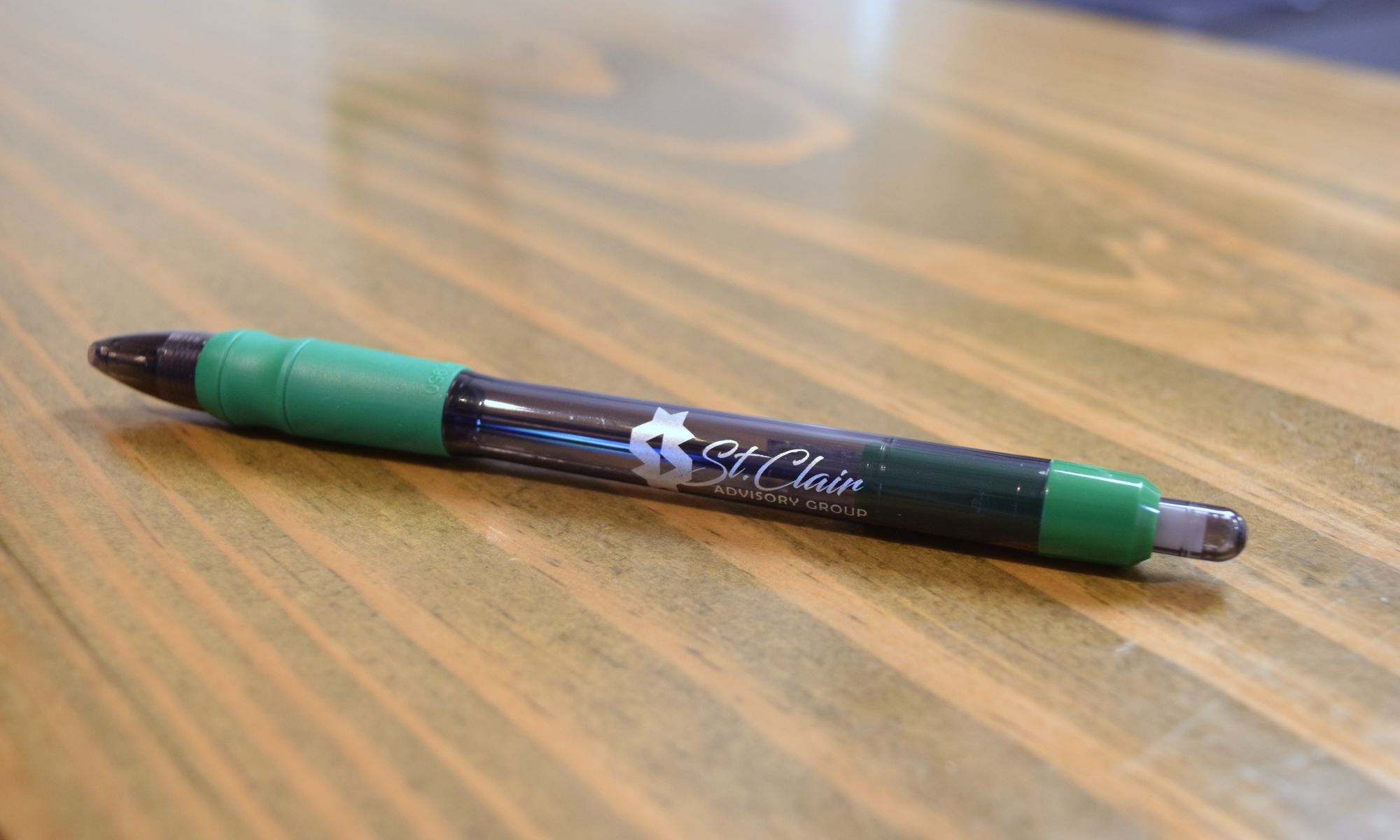 St. Clair branded pen on a wood desk