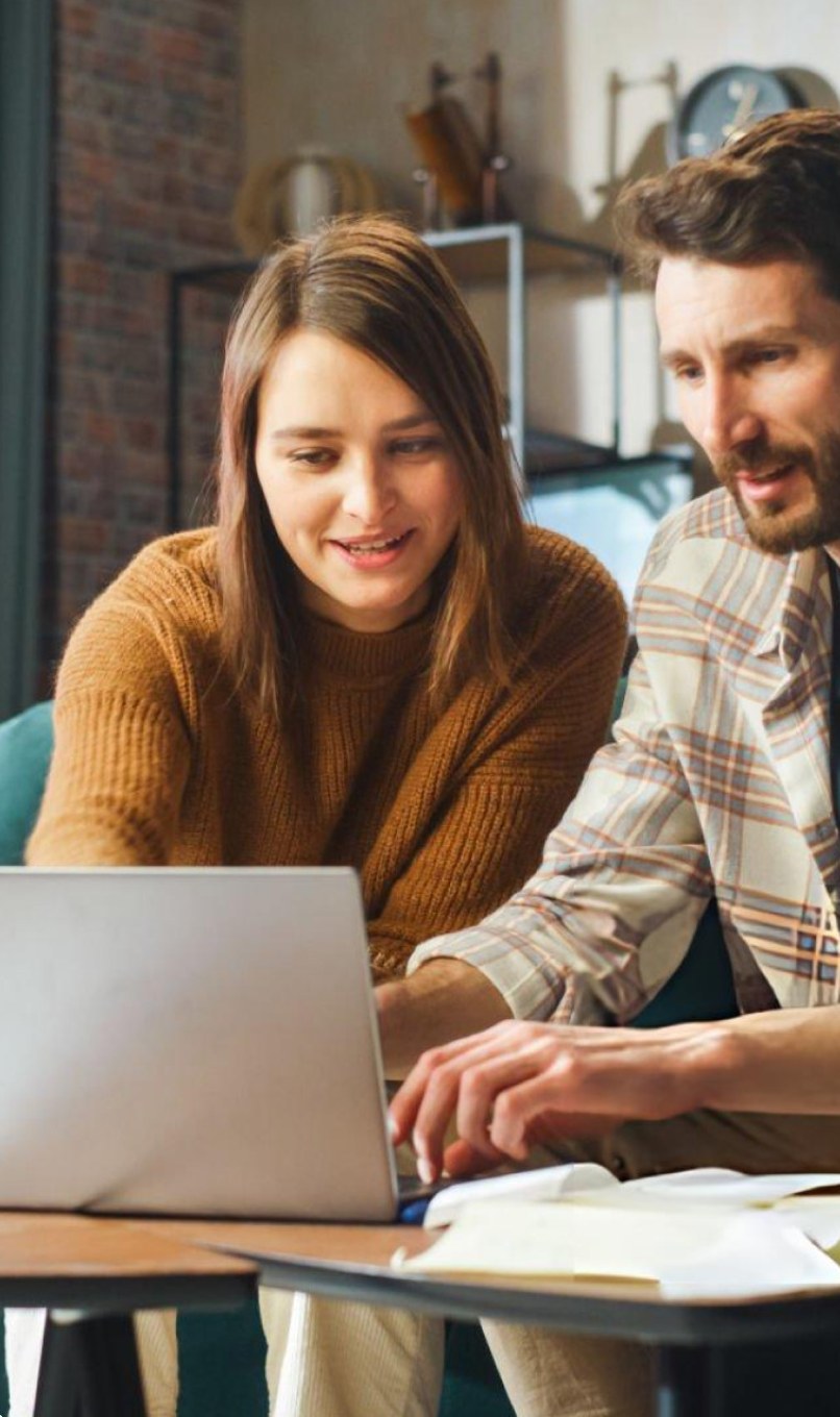 Clients reviewing their tax plan together on a laptop