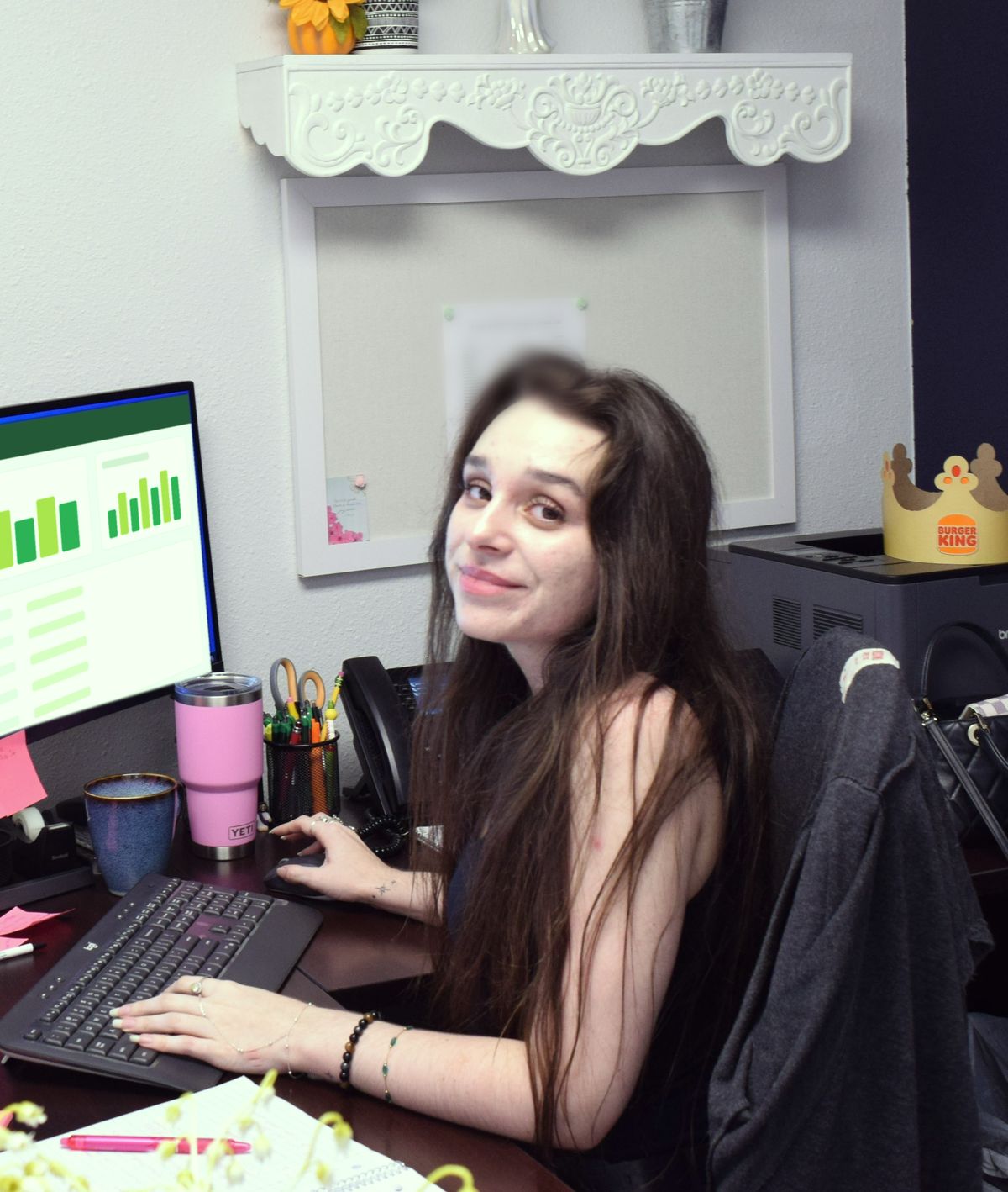 A St. Clair team member smiling at her desk